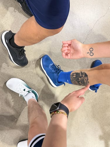 Reviewer and friends showing off their CUURT Muuv court shoes in black, blue, and white.