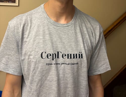 Close-up of a customer wearing the grey Sergei Tee with its black printed text.
