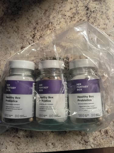Customer's three bottles of Healthy Box Probiotics in clear packaging on a countertop.