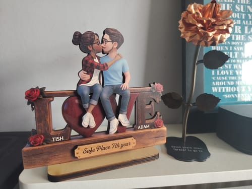 Customer's personalized wooden 'LOVE' plaque with a kissing couple, showing the names "Tish" and "Adam".