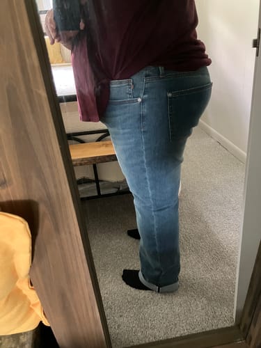 Customer wearing the Judy Blue boyfriend jeans, showing a side view of the relaxed fit with cuffed ankles.