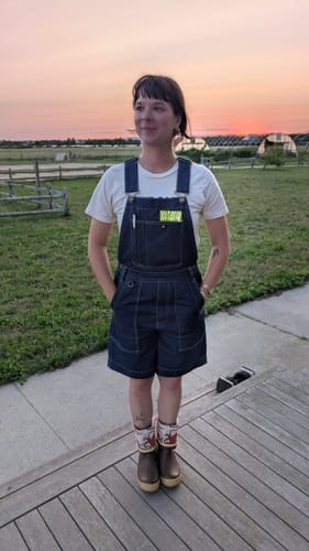Customer standing outdoors wearing the Denim Cropped Brumby Suit with a white t-shirt and boots.