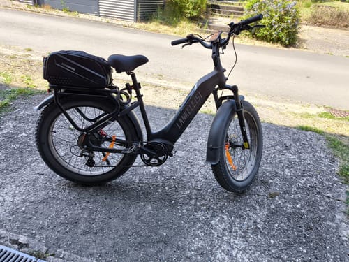 Customer's black Lankeleisi MG600 Plus e-bike parked on a driveway with a large storage bag on the rear rack.
