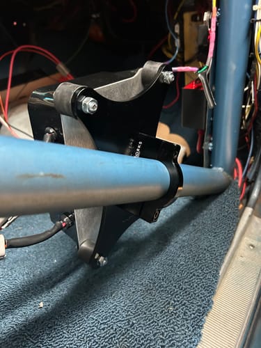 Reviewer's black MSD Grid 7 Swiveling Roll Bar Mount installed on a light blue roll bar inside a vehicle.