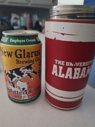 Customer's red and white Alabama Universal Buddy can cooler sitting on a counter next to a can of beer.