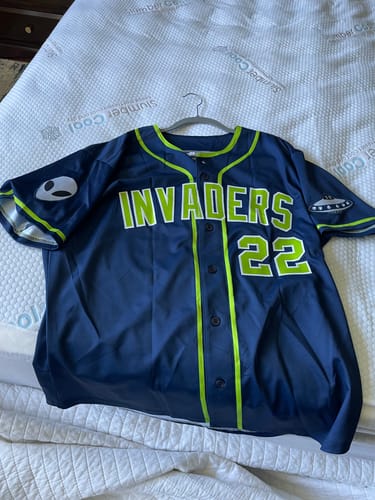 Customer's custom navy and neon green baseball jersey with 'INVADERS 22' and alien patches on the front.