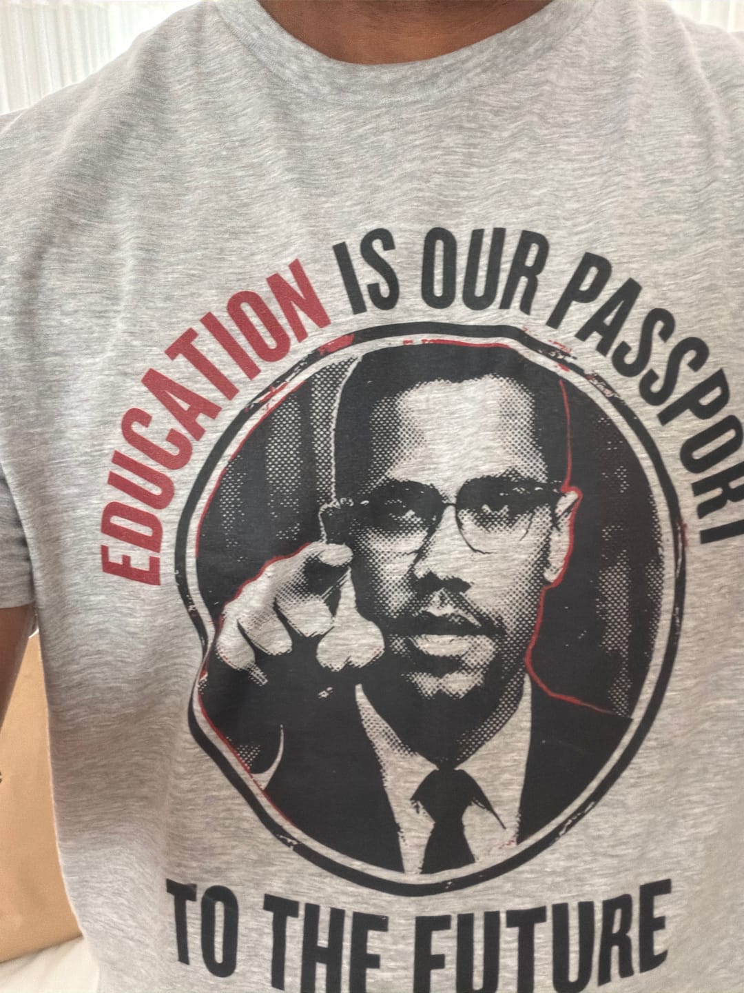 Customer photo review of Education Is Our Passport Tee