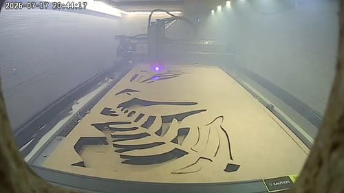 Customer's AtomStack A40 Pro V2 Laser Engraver in action, cutting a large design into a sheet of material in its enclosure.