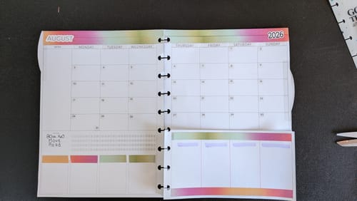 Reviewer's Scout Planner Insert Pack open to a monthly calendar view, showing the discbound format with weekly pages below.