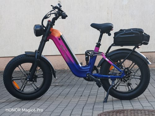 Customer's CMACEWHEEL V20 fat bike featuring a gradient pink and blue frame parked on a paved surface.
