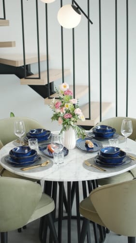 Reviewer's Ocean Blue Dinnerware Set shown on an elegant dining table set for four.