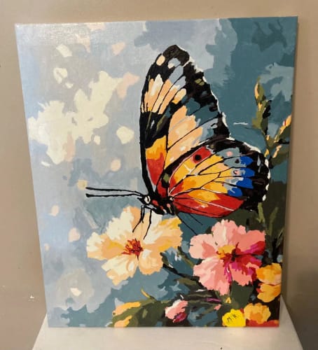 Customer's Custom Paint by Numbers butterfly artwork with bright, colorful wings resting on flowers
