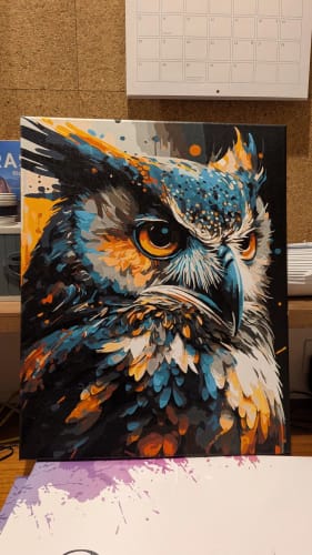 Customer's completed owl portrait from the Custom Paint By Numbers kit, featuring vibrant blue and orange hues.