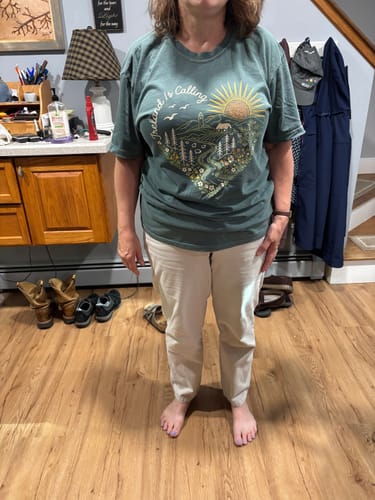 Customer's Ireland is Calling Heart T-Shirt, a green shirt with a nature scene design, worn by the reviewer.