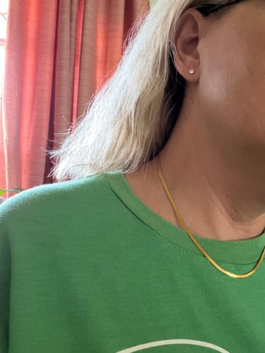Customer's gold Chelsea Herringbone Necklace worn as a choker around the neck.