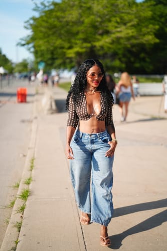 Customer's Naked Print Wire Crop Top with abstract polka dot pattern, worn walking outdoors.