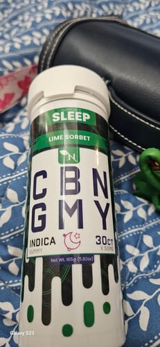 Customer's Lime Sorbet CBN Gummies bottle for sleep, resting on a blue patterned blanket