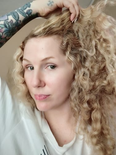 Reviewer's face showing smooth skin, looking radiant after using the Seranova Micro Infusion System.