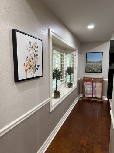Customer's Colorful Branches canvas art mounted on a gray wall in a hallway