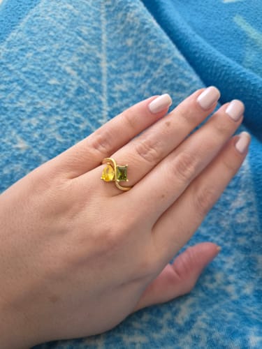Customer's Forever Duo Birthstone Ring with yellow and green stones worn on a person's hand.