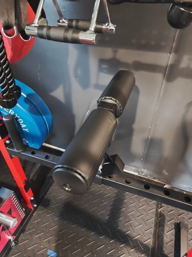 Customer's black RitFit LHM1 Leg Holder Attachment mounted to a rack in a home gym.