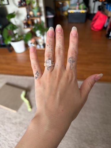 Customer's hand wearing the GlowStone Collection silicone ring with an emerald-cut stone on their ring finger.