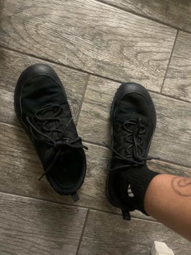 Customer's black Forestep I barefoot shoes being worn on a tiled floor.