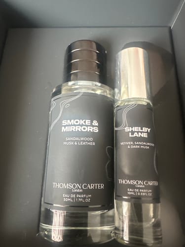 Customer's Smoke & Mirrors fragrance bottle next to a Shelby Lane sample bottle inside a box.