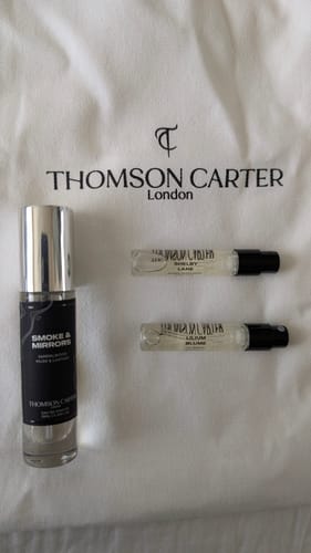 Customer's Lilium Blume perfume sample bottle displayed on a white Thomson Carter branded fabric bag.