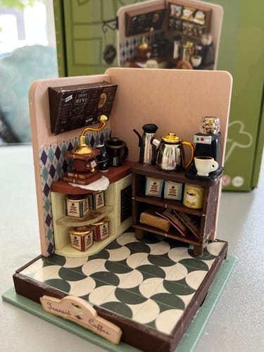Customer's completed The Daily Grind miniature coffee bar kit featuring a grinder, kettles, and detailed decor.