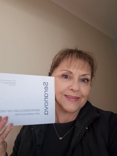 Customer's Seranova Micro Infusion System product box held in hand