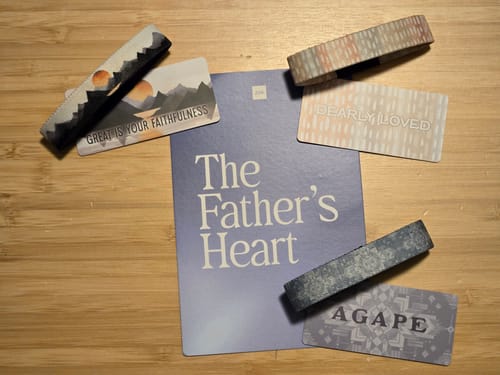 Customer's June Bible Club items laid out, showing three patterned bracelets and cards for 'The Father's Heart' theme.