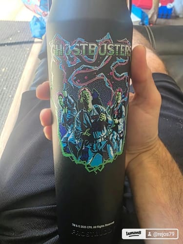 Customer holding their black Ghostbusters Bottle Buddy, showing the colorful graphic of the movie's characters.