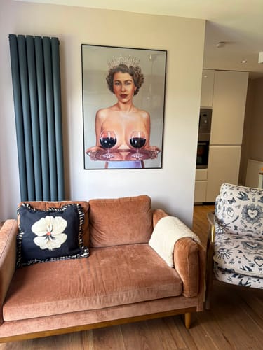 Customer's large, framed Majestic art print featuring a royal figure hanging on a living room wall.