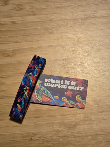 Customer's colorful What If It Works Out bracelet and matching turtle-themed card on a wooden surface.