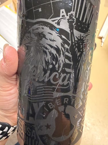 Close-up of a customer's black Universal Buddy, showing a scratch across the patriotic design mentioned in the review.
