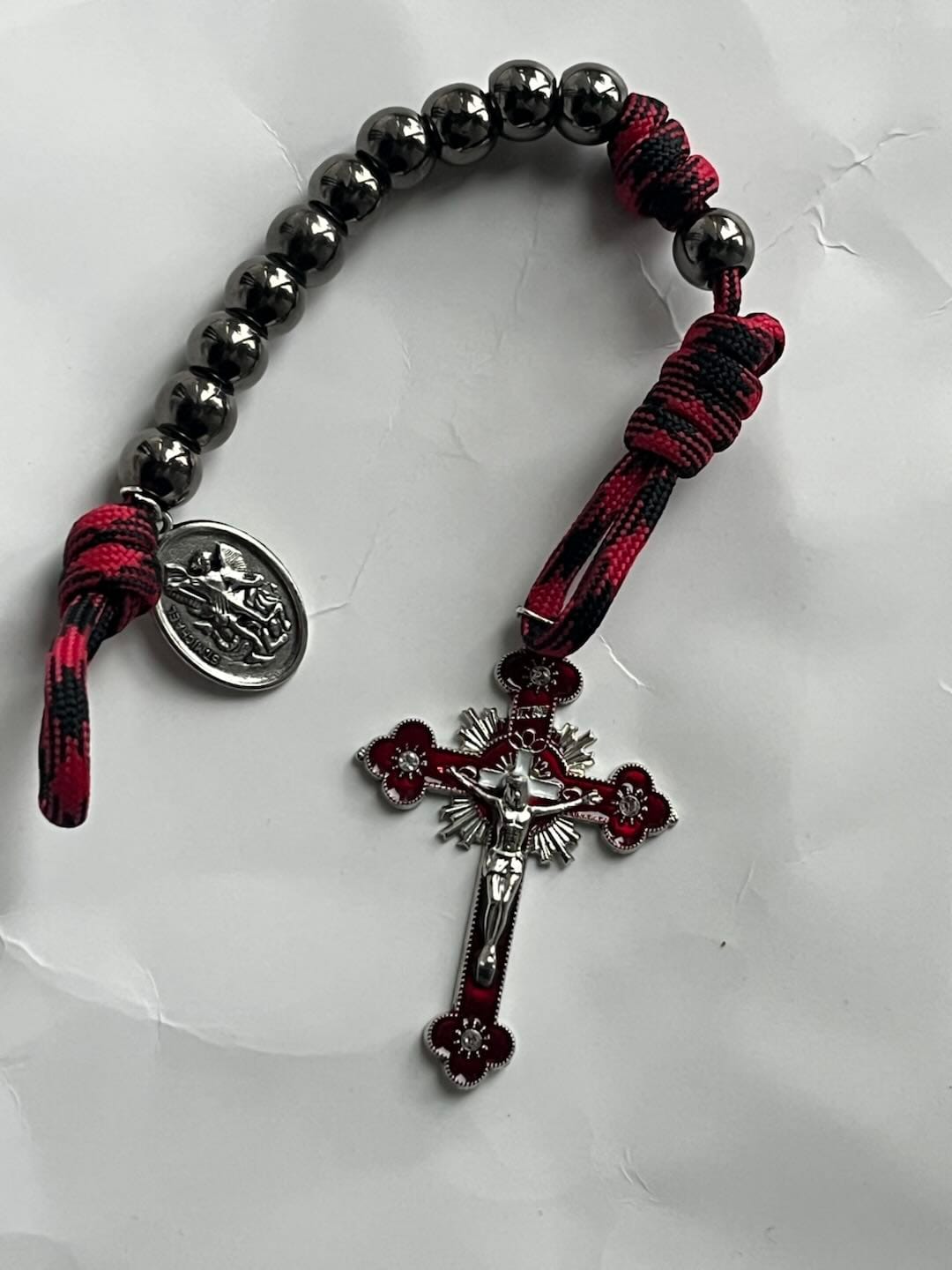 Customer photo review of Solacebeads Gunmetal Bead Car Rosary & Red Enamel Crucifix: Rooted In St. Michael Protection