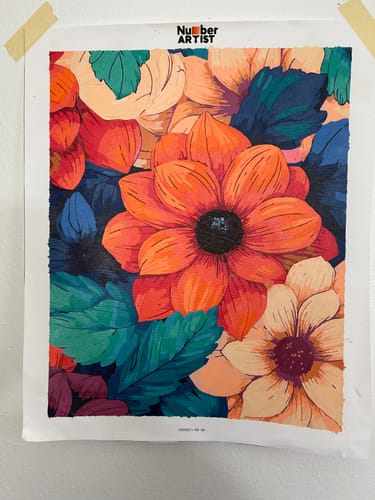 Reviewer's finished Vibrant Petals paint by numbers project featuring bright orange flowers and teal leaves.