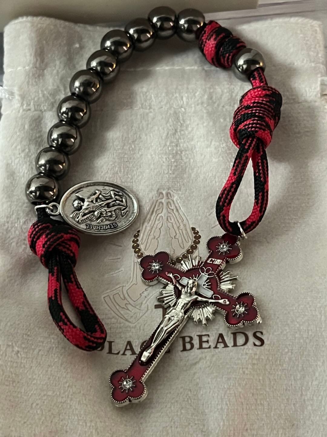 Customer photo review of Solacebeads Gunmetal Bead Car Rosary & Red Enamel Crucifix: Rooted In St. Michael Protection