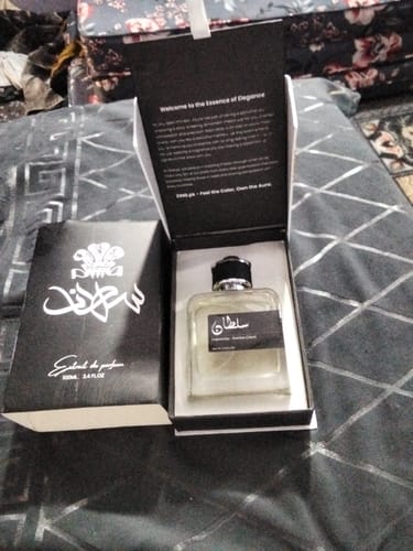 Customer's Sultan perfume bottle placed in its open black and white gift box.