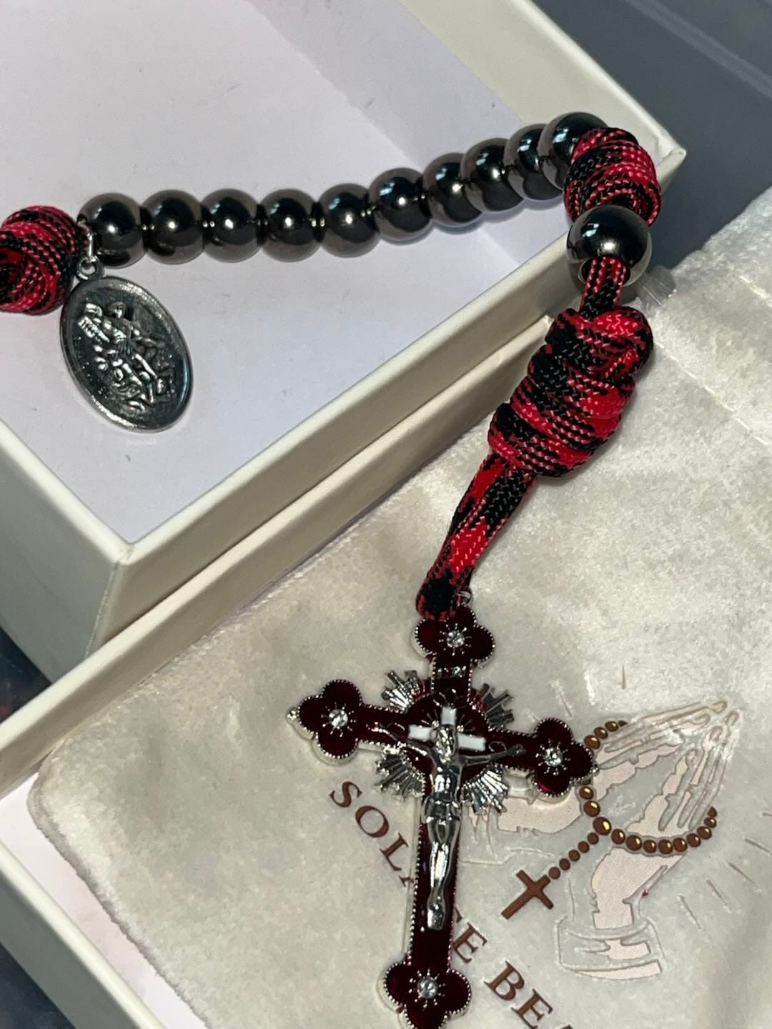 Customer photo review of Solacebeads Gunmetal Bead Car Rosary & Red Enamel Crucifix: Rooted In St. Michael Protection