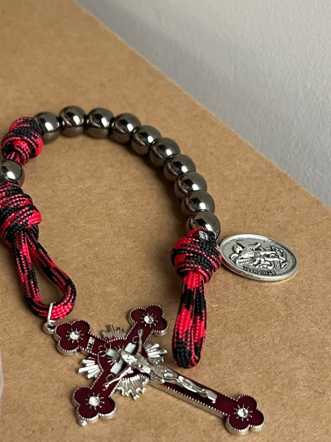 Customer photo review of Solacebeads Gunmetal Bead Car Rosary & Red Enamel Crucifix: Rooted In St. Michael Protection