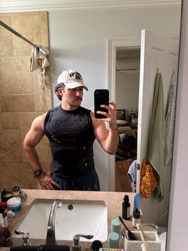Customer's Superman Compression Tank worn by a reviewer in a bathroom mirror selfie