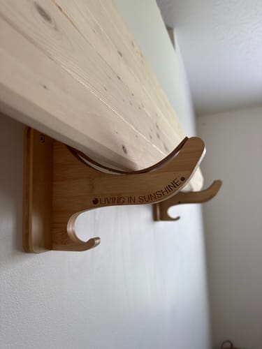 Customer's Single Rack bamboo wall mount with a visible Living in Sunshine logo etched on the side.