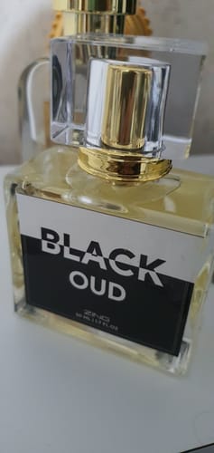 Customer's Black Oud bottle from The Royal Oud Collection with a clear glass cap and gold accent.