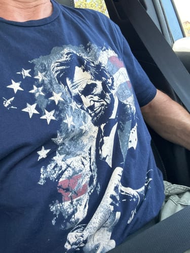 Customer's Lincoln Flag T-Shirt in blue, featuring a graphic print of Abraham Lincoln over an American flag.