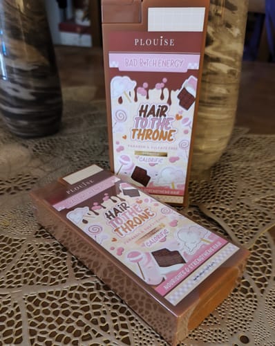 Customer's Hair To The Throne Shampoo & Conditioner bundle in Calorific scent, shown in rectangular brown packaging.