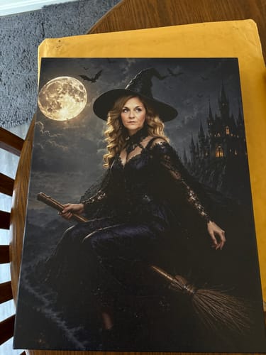 Customer's Midnight Witch canvas print featuring a person in a black gown and witch hat riding a broom.