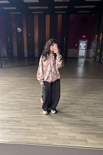 Customer's Baggy Ass Sweats in black, showing the oversized, relaxed fit while standing in a gym.