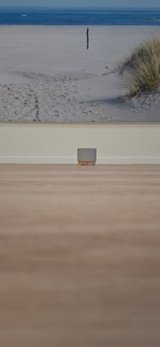 Customer's Satori Concrete diffuser in a light gray finish with a wooden base, placed on a wooden floor.